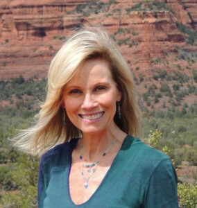 Debra Beck, Sedona soul retrieval healer, smiling in front of red rock formations